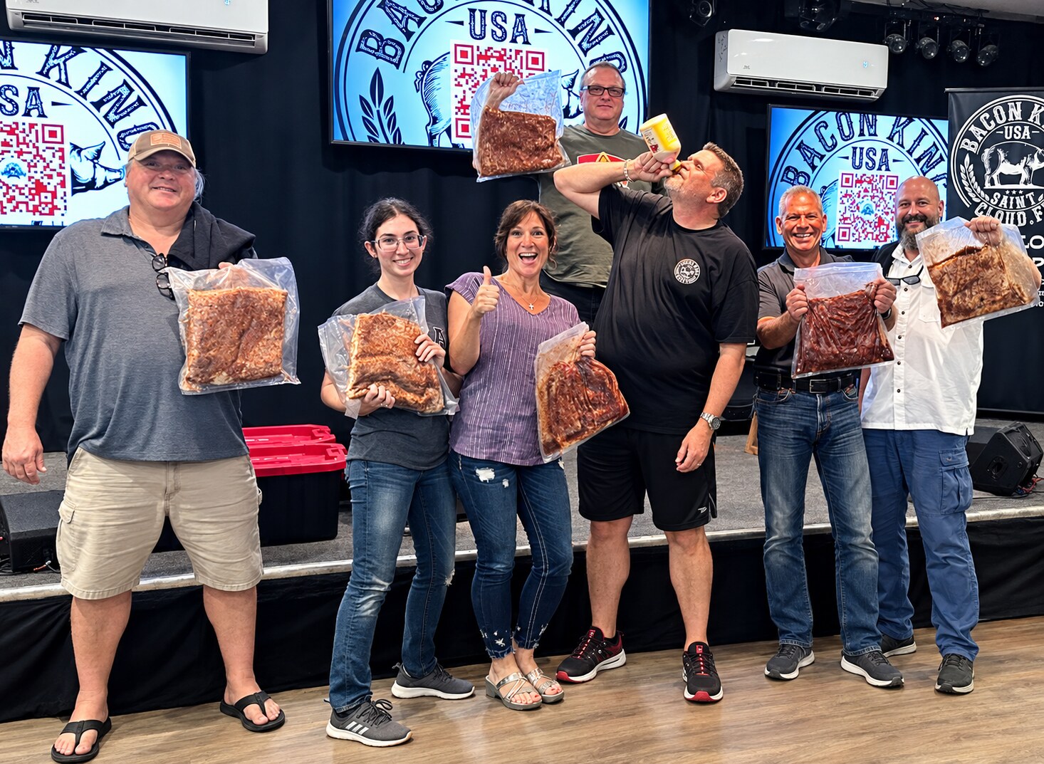 A live Bacon King Experience group holding the bacon they created
