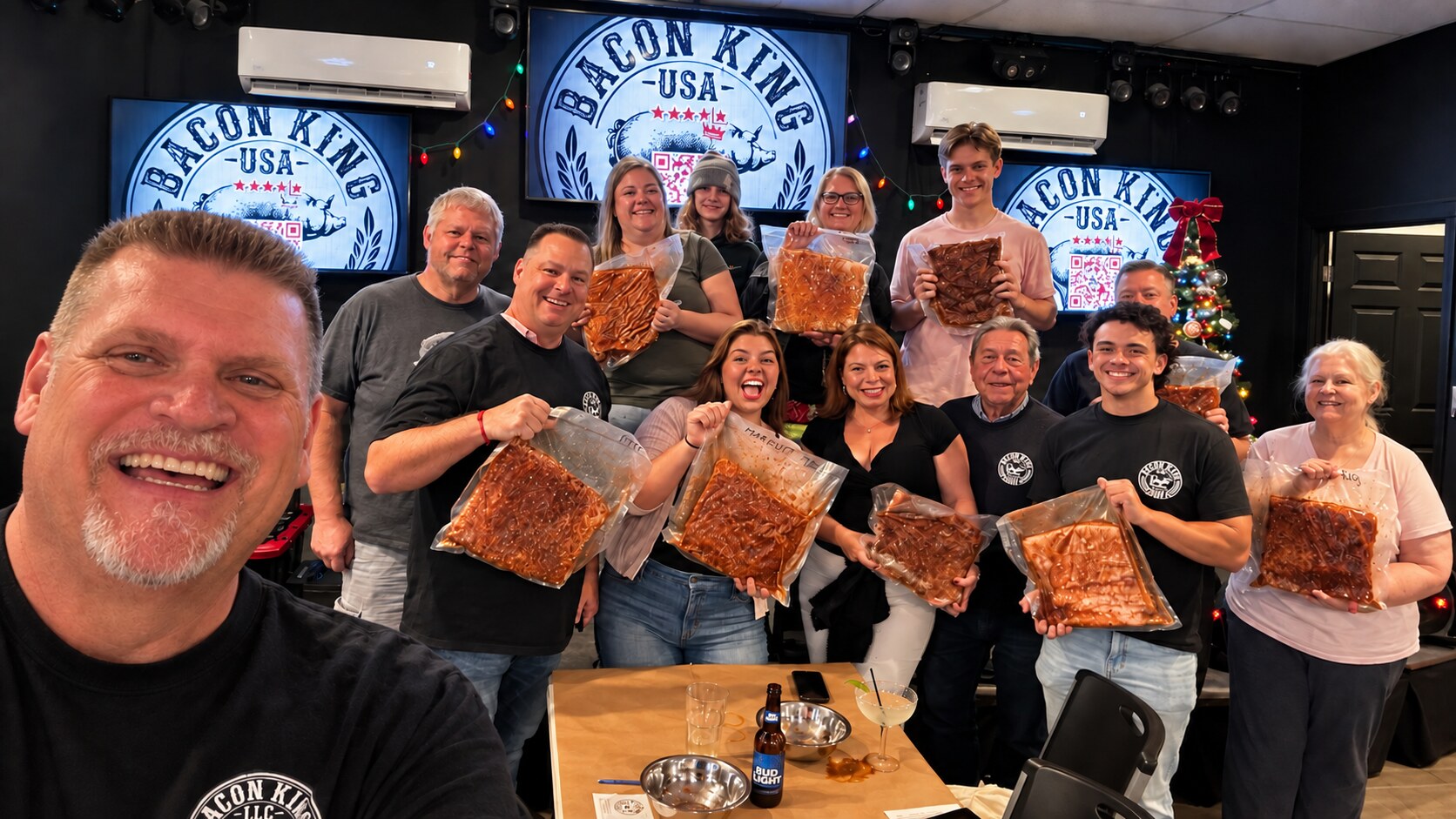 The Bacon King celebrating with Bacon King Experience participants and the bacon they created
